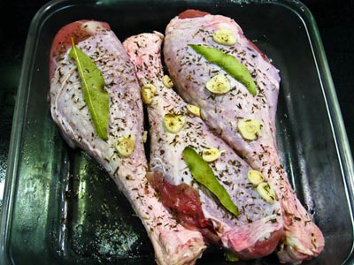 raw turkey legs with bay, garlic, thyme, clove