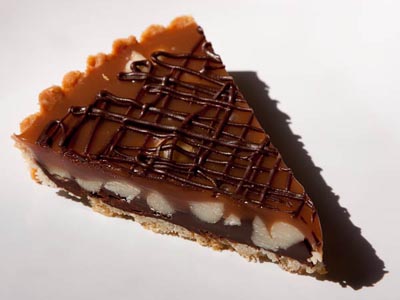 slice of chocolate caramel macadamia nut tart